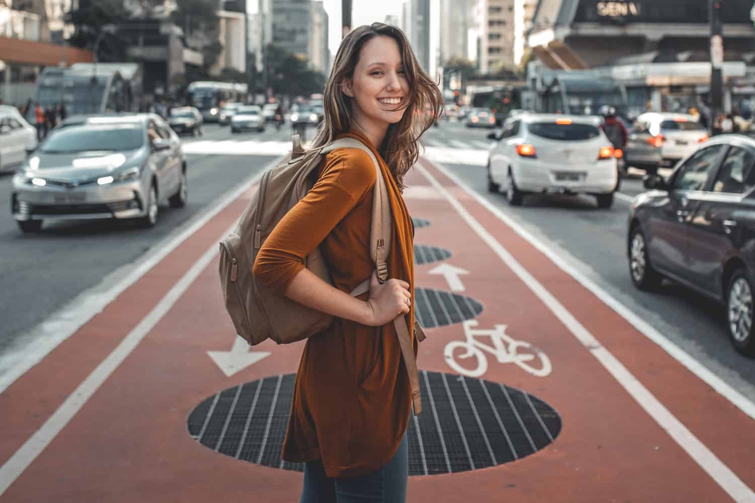 girl with backpack walking in the street